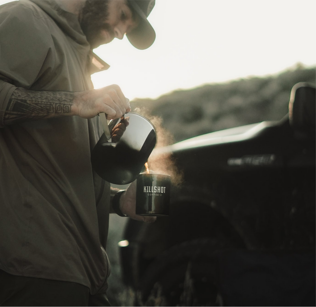 Hunter drinking low-acid Killshot Coffee before sunrise to avoid stomach burn and stay focused during the hunt.